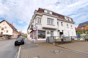 a car parked in front of a white building at Az-Living Feudenheim in Feudenheim