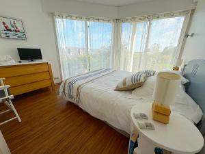 a bedroom with a bed and a table and a window at Villa du Rocher in Sibiril +28 photos