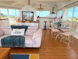 a living room with a couch and a table at Villa du Rocher in Sibiril