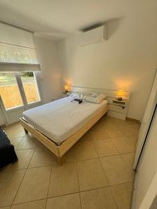 a bedroom with a bed in a room with a window at Villa avec piscine à quelques minutes de la mer in Lumio