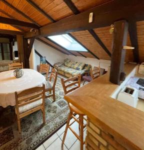 a living room with a table and chairs and a couch at Ferienwohnung Baumann in Bad Endbach
