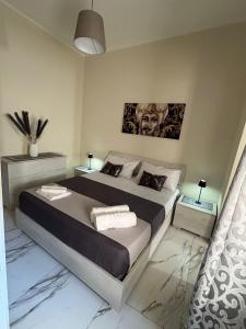 a bedroom with a large bed in a room at Vicolo30 in Catania