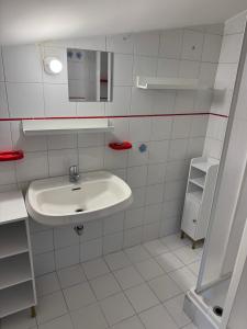 a white bathroom with a sink and a mirror at A Casa di Micol in Poggio Mirteto