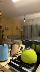 a green tea kettle on a table in a living room at بلكونه 7 in Taif