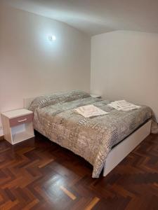 a bedroom with a bed and a wooden floor at A Casa di Micol in Poggio Mirteto +10 photos