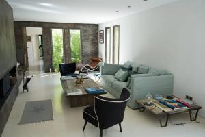 a living room with a couch and a table at La Matina Family Haven with Olive Garden Oasis in Lauris
