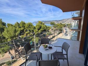 a table and chairs on a balcony with a view at Sunset Luxury Apartment Shengjin in Lezhë