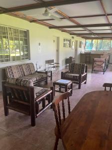 a living room with couches and a table and chairs at Proudly Okavango self-catering Burnside in Shakawe