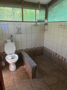 a bathroom with a toilet and a bath tub at Proudly Okavango self-catering Burnside in Shakawe +24 photos