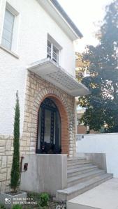 a dog standing in the door of a house at Suite studio Darcy in Dijon