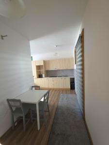 a kitchen and dining room with a table and chairs at Bistrycia in Vilnius