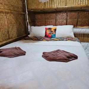 a bed with two towels on top of it at Long beach simple House in Ko Lanta +112 photos
