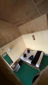 an overhead view of a bedroom with a large bed at ATC Samalbong Paharer Bari in Kalimpong