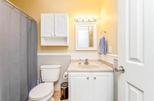 a bathroom with a white toilet and a sink at Reilly Road Refuge in Fort Bragg +14 photos