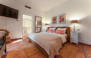 a bedroom with a large bed with red pillows at Villa Son Max in Port d’Andratx +24 photos