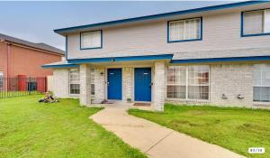 a house with blue doors and a grass yard at Modern 2BR Stay with Large Parking Pet Friendly in Killeen