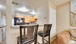 a kitchen with two chairs and a bar in a room at Modern 2BR Stay with Large Parking Pet Friendly in Killeen