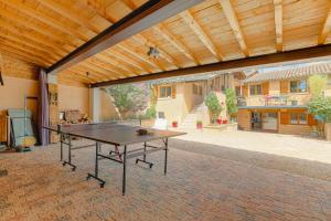 a ping pong table in the middle of a patio at Les Aubépines en Beaujolais in Salles-Arbuissonnas