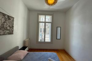 a bedroom with a bed and a window at Les Pieds dans le Bassin in Le Havre