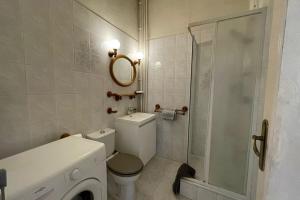 a bathroom with a toilet and a glass shower at Les Pieds dans le Bassin in Le Havre
