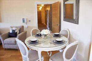a white table and chairs in a living room at The Palm Suite in Southport