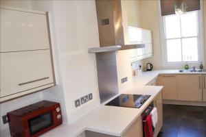 a kitchen with a red microwave on a counter at The Palm Suite in Southport