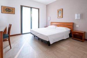 a bedroom with a bed and a desk and a window at Eurobeach Residence in Cavallino-Treporti +43 photos