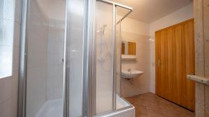 a bathroom with a shower and a sink at Chalets am Feuerkogel - LANDLUFT in Ebensee +41 photos