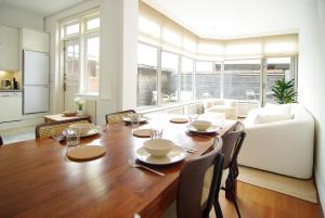 a dining room with a wooden table and chairs at spacious new appartment in Lisse