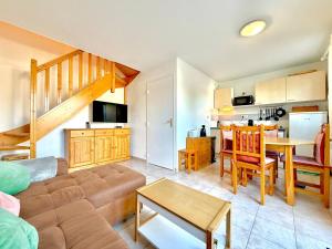 a living room with a couch and a table at L’Écrin du Mas, 4 pers Piscine à Calvisson in Calvisson