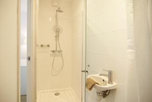 a bathroom with a shower and a sink at spacious new appartment in Lisse