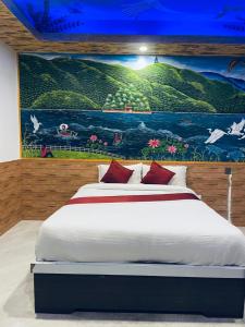 a bedroom with a bed with a painting on the wall at Kahun Danda Resort in Pokhara +19 photos