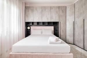 a bedroom with a large white bed with a headboard at Urban Nest - Parco Nord Milano in Sesto San Giovanni