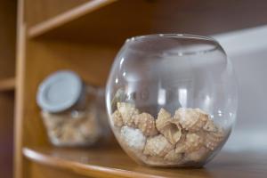 a glass vase filled with peanuts on a shelf at Home2Book Sunny Terrace Getaway Puerto Lajas in Puerto de las Lajas +18 photos