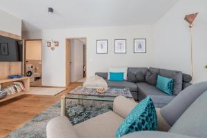 a living room with a couch and a table at BioTop Appartement Kronplatz in Perca