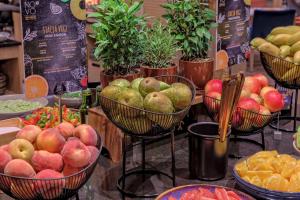a bunch of baskets of fruit on a table at Novotel Kraków Centrum in Krakow +160 photos