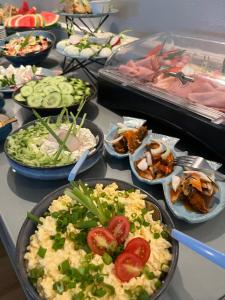 a buffet with many plates of food on a table at Ach Mazury in Mikołajki
