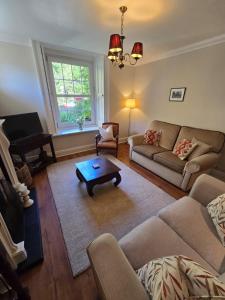 a living room with a couch and a coffee table at Grebe Cottage in Isle of Wight