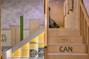 a room with a staircase with a door with the words you can at Novotel Kraków Centrum in Krakow