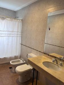 a bathroom with a toilet and a sink at Yerbabuena in Yerba Buena