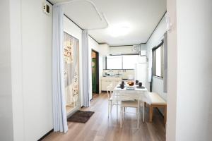 a kitchen and dining room with a table and chairs at 302 Grand Maison konohana 予約制駐車場,USJや海遊館に最適,駅から徒歩6分 in Osaka
