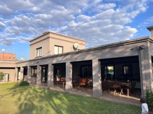 a house with large glass doors and a yard at Yerbabuena in Yerba Buena