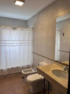 a bathroom with a toilet and a sink at Yerbabuena in Yerba Buena