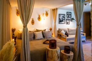 a bedroom with a bed with two logs on it at Sonnmatten Boutique Hotel & Apartments Zermatt in Zermatt