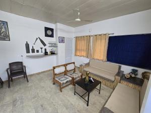 a living room with a couch and a table at H M farm in Surajpur