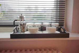 a tray with cups and jars on a window sill at The Alma Taverns Boutique Suites - Room 4 - Hopewell in Bristol