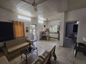 a large living room with a couch and a tv at H M farm in Surajpur