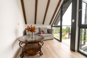 a living room with a table and a couch at Cabana din padure in Agapia