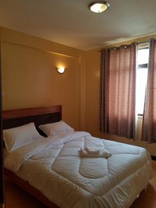 a bedroom with a bed with two towels on it at Almasi airport view apartment in Syokimau