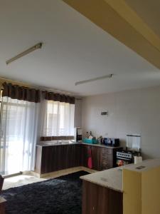 a kitchen with a stove and a counter top at Almasi airport view apartment in Syokimau +2 photos